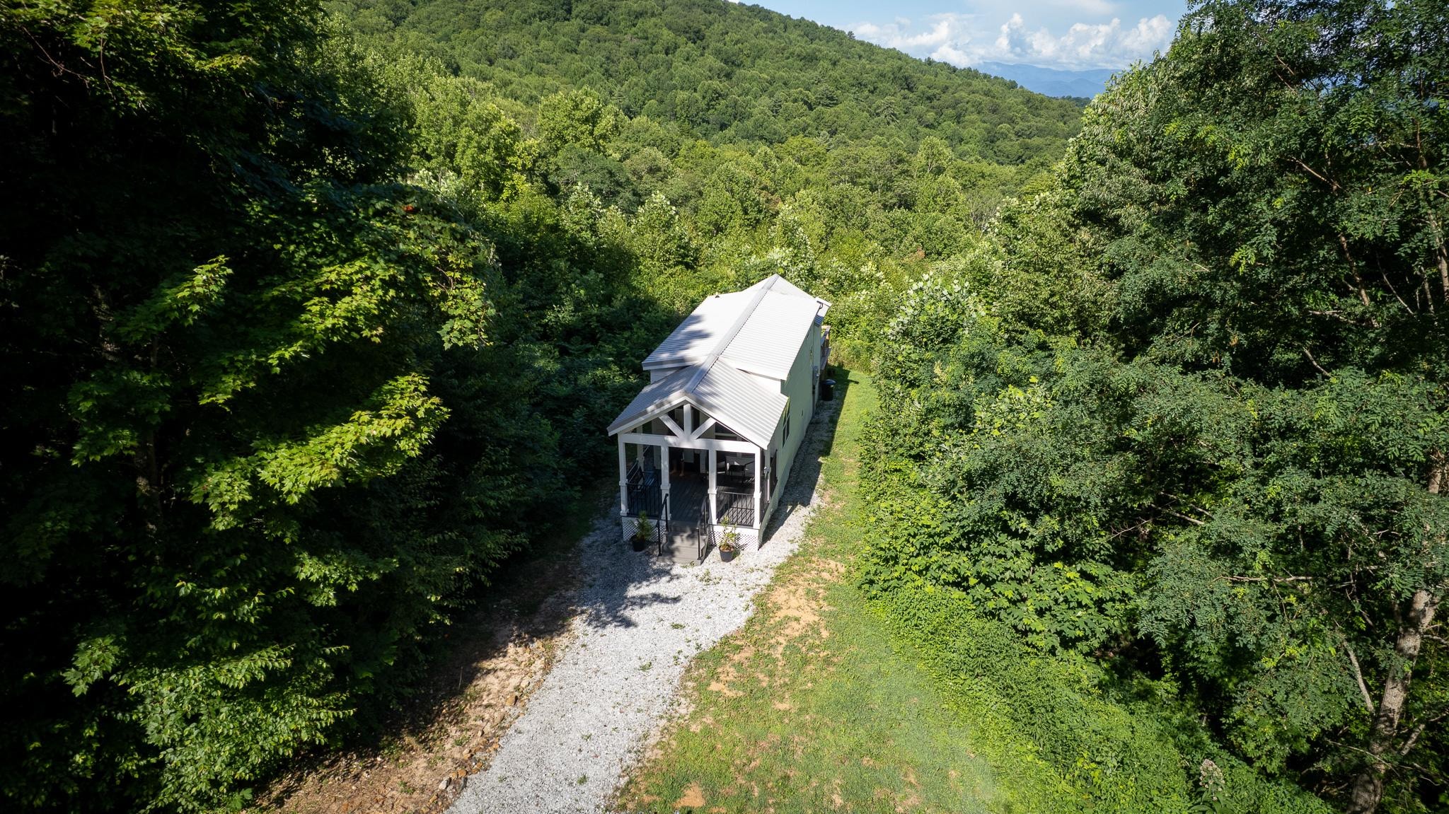 Low aerial view of cottage and driveway