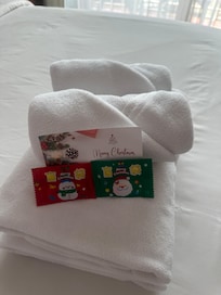 A gift and hand written card on the bed each day.