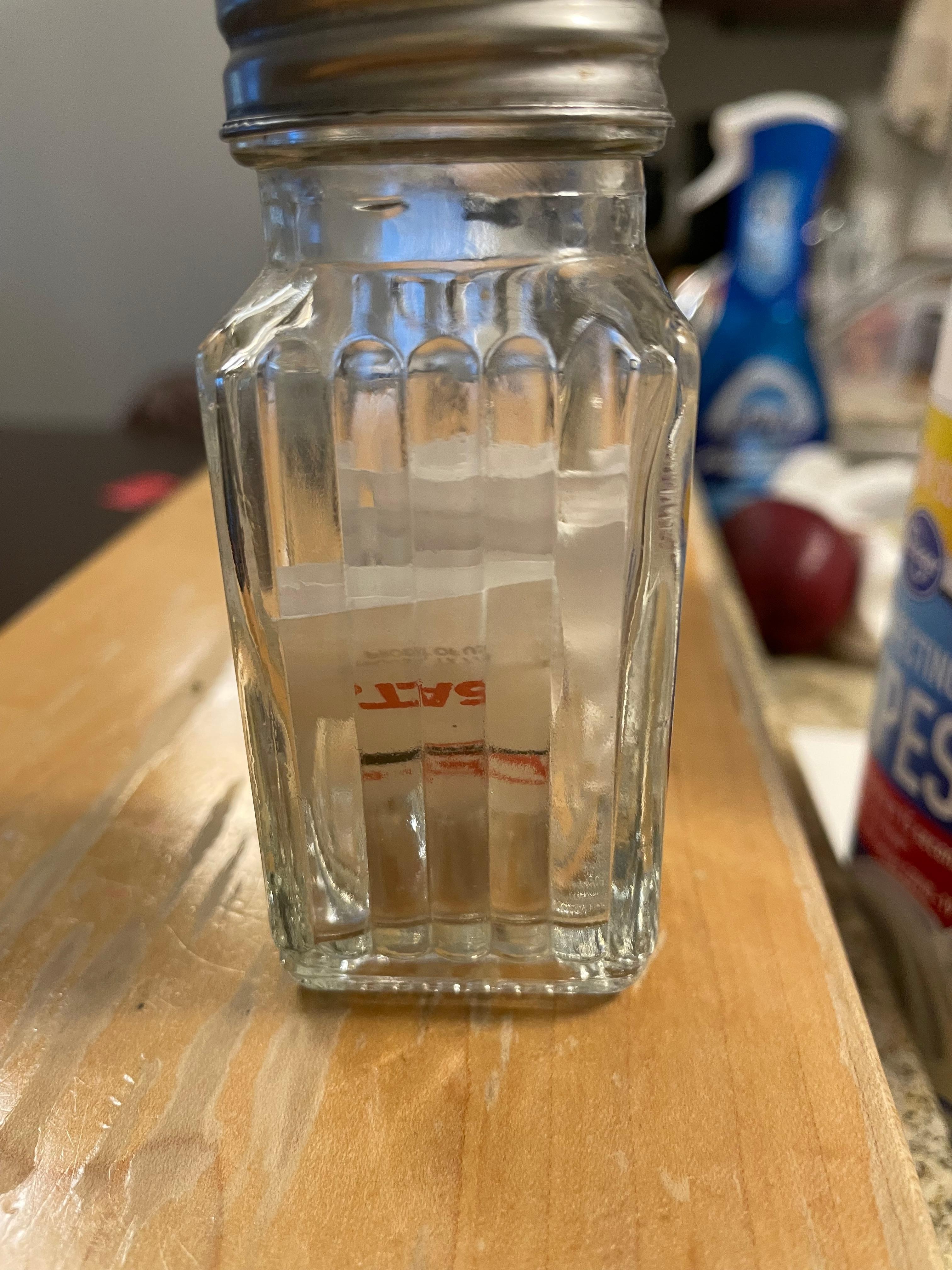 Salt shaker filled with individual packets of salt. Kinda funny but inconvenient for salting. 
