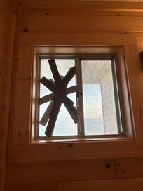 Bathroom window broken and dirty with dirt on window seal.