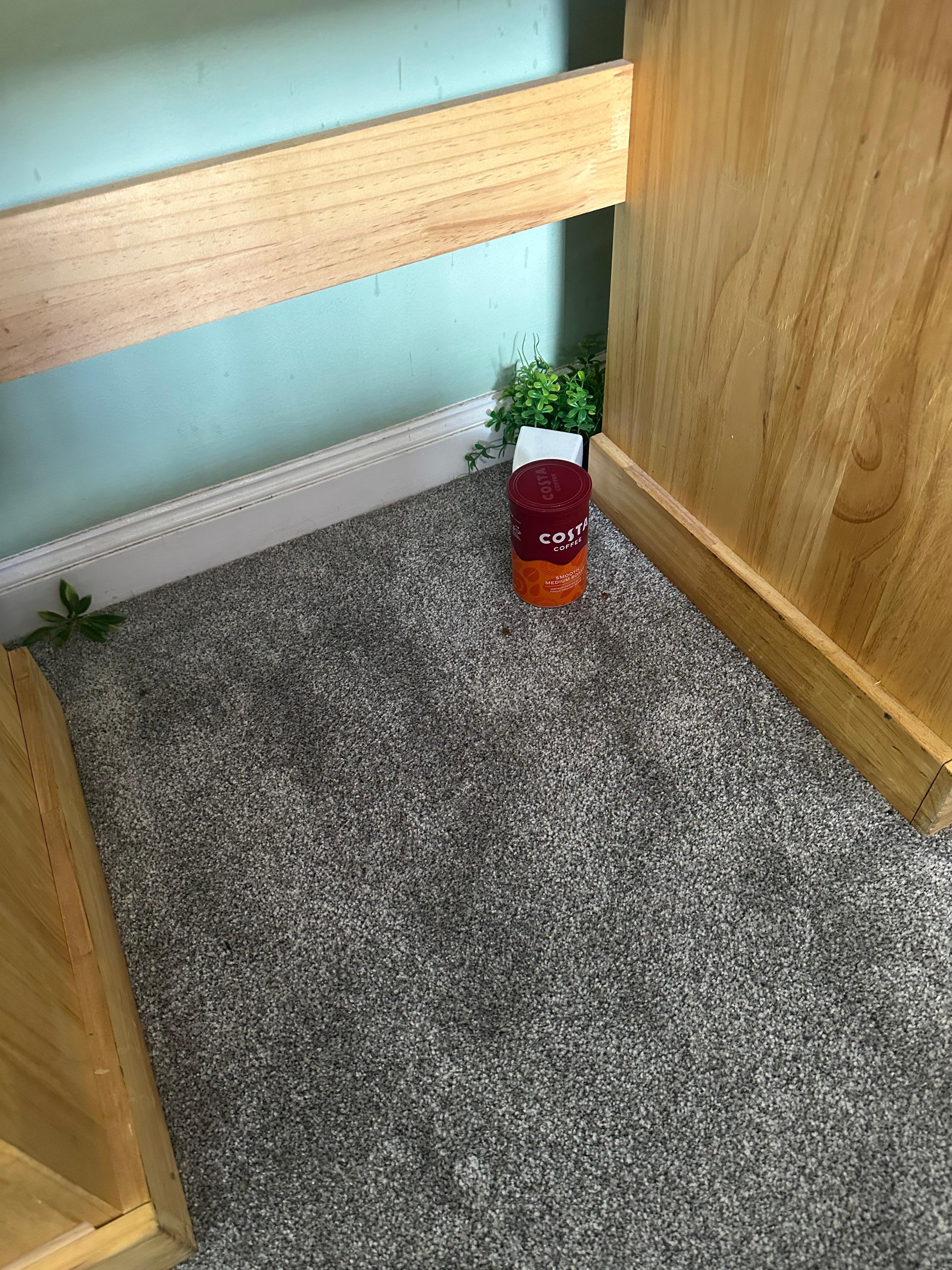Discarded tub of coffee under table