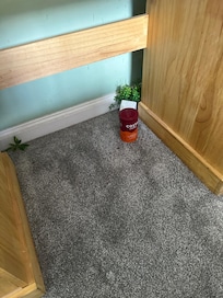 Discarded tub of coffee under table