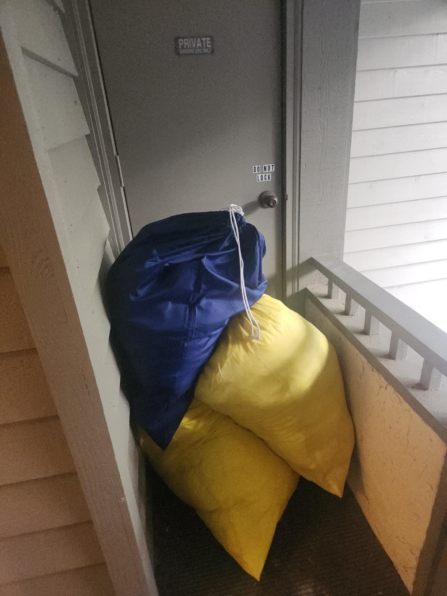 BAGS OF LAUNDRY BY DOOR SHOULD BE LEFT DOWNSTAIRS