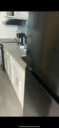 Refrigerator, sink w/a lil counter space and stove plus microwave
