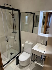 The bathroom has a nice large shower.