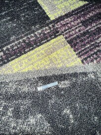 Needle cap in hallway.