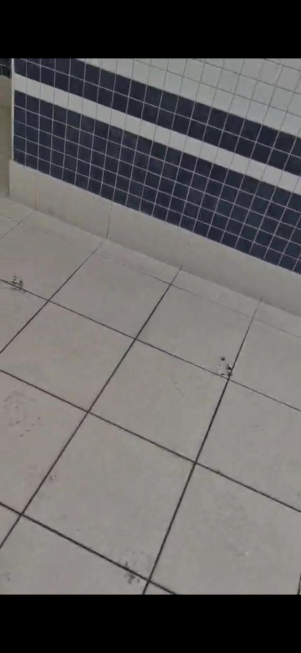 Construction workers foot steps mud entering pool water