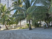 The Cute Beach Studio building is with the blue box air condition coverings.
