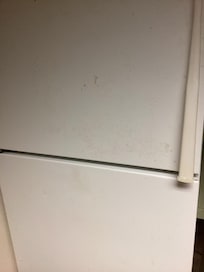 Discolored and dirty refrigerator.