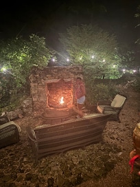 Fire pit outside back with wood.