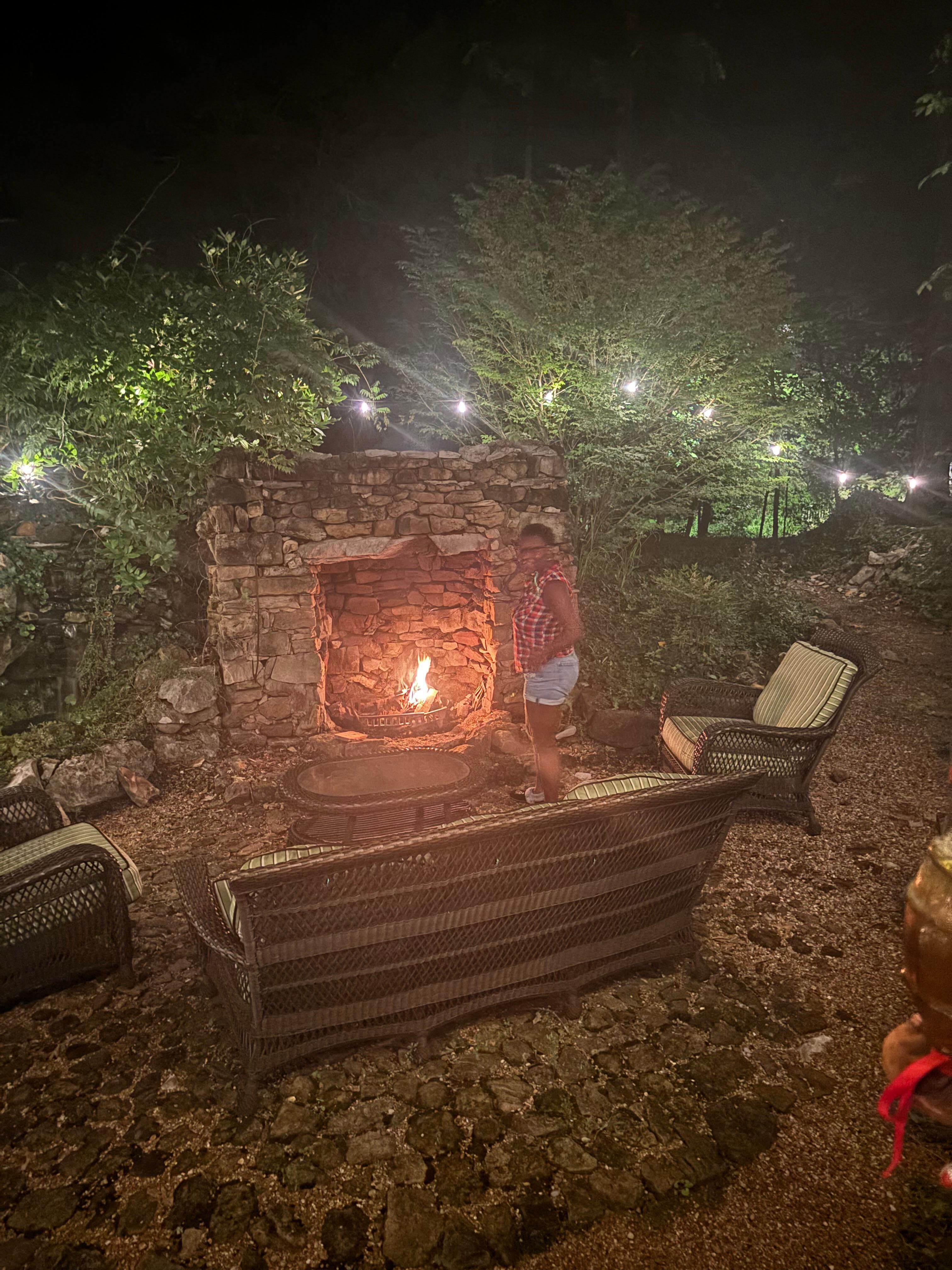 Fire pit outside back with wood.