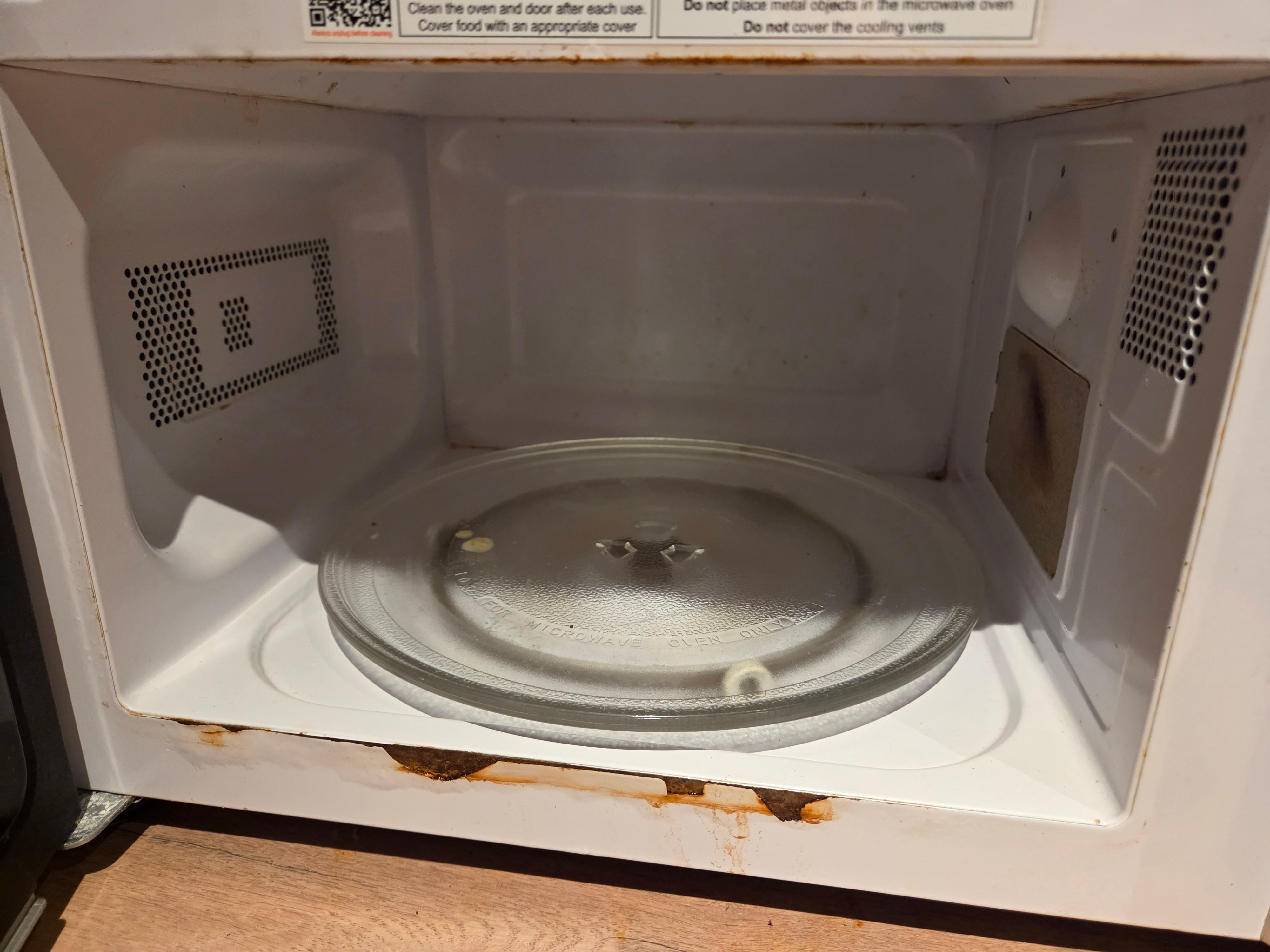 Filthy microwave. Rusted. Moldy. Old and unhealthy.  Disgusting.