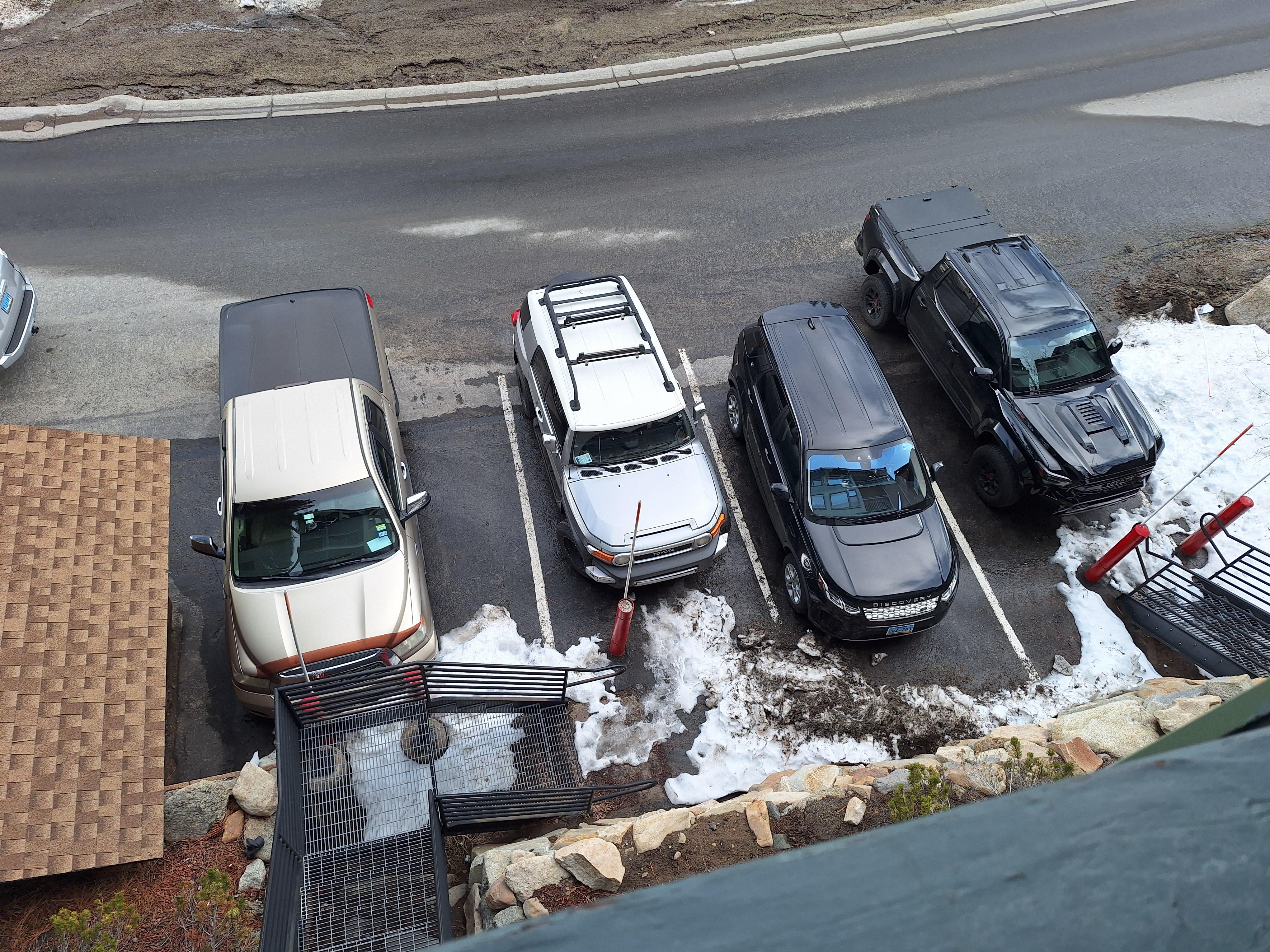 Only 4 dedicated parking spots with 8 permits issued.