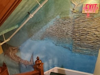 Hall wall art along stairwell.