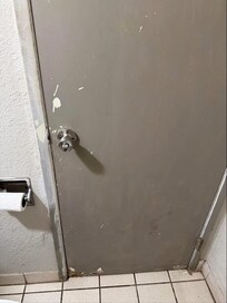 Dirty, chipped bathroom door.