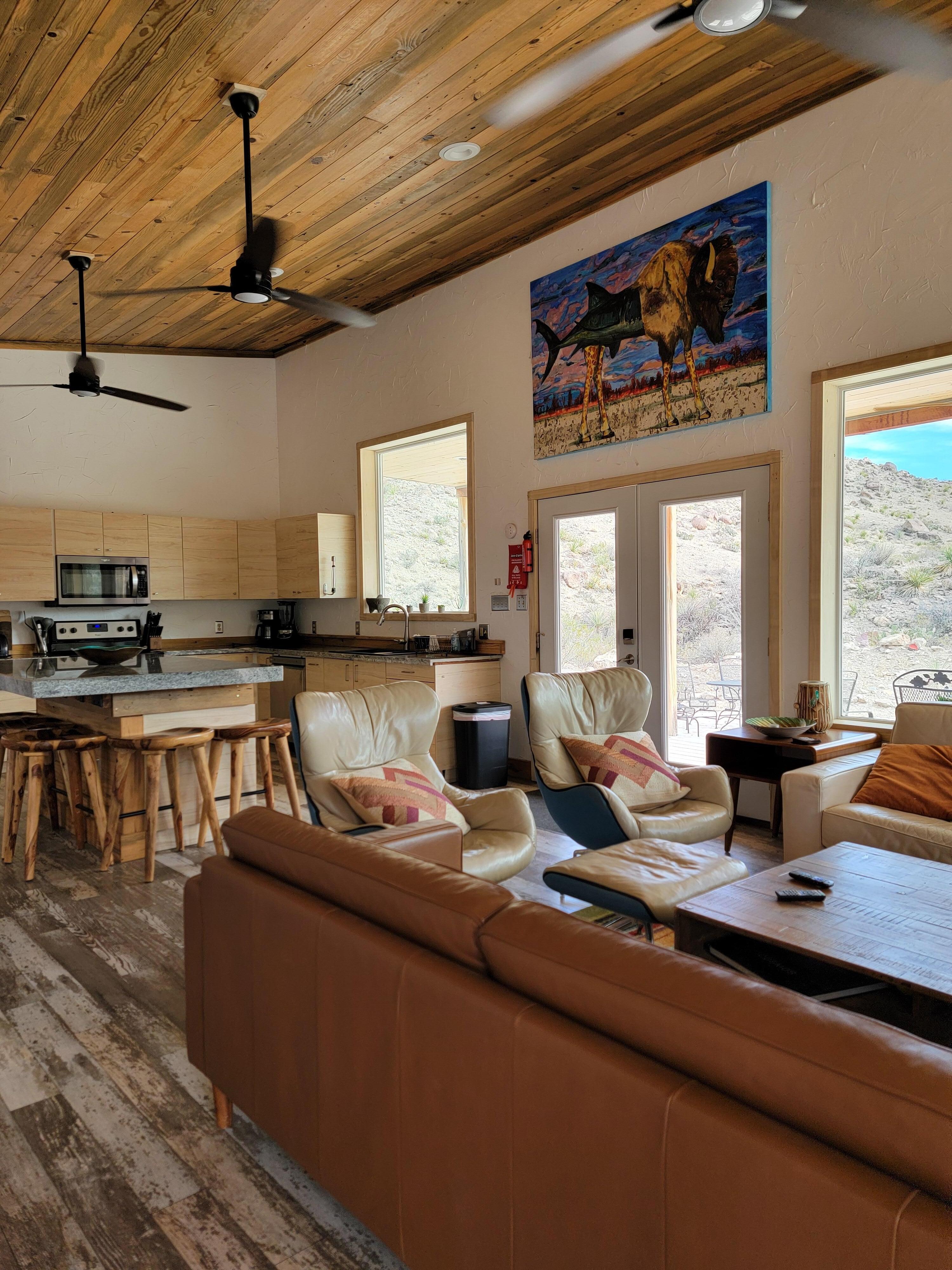 Spacious kitchen and comfy couches and chairs