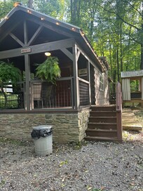 Charming cabin with covered hot tub.