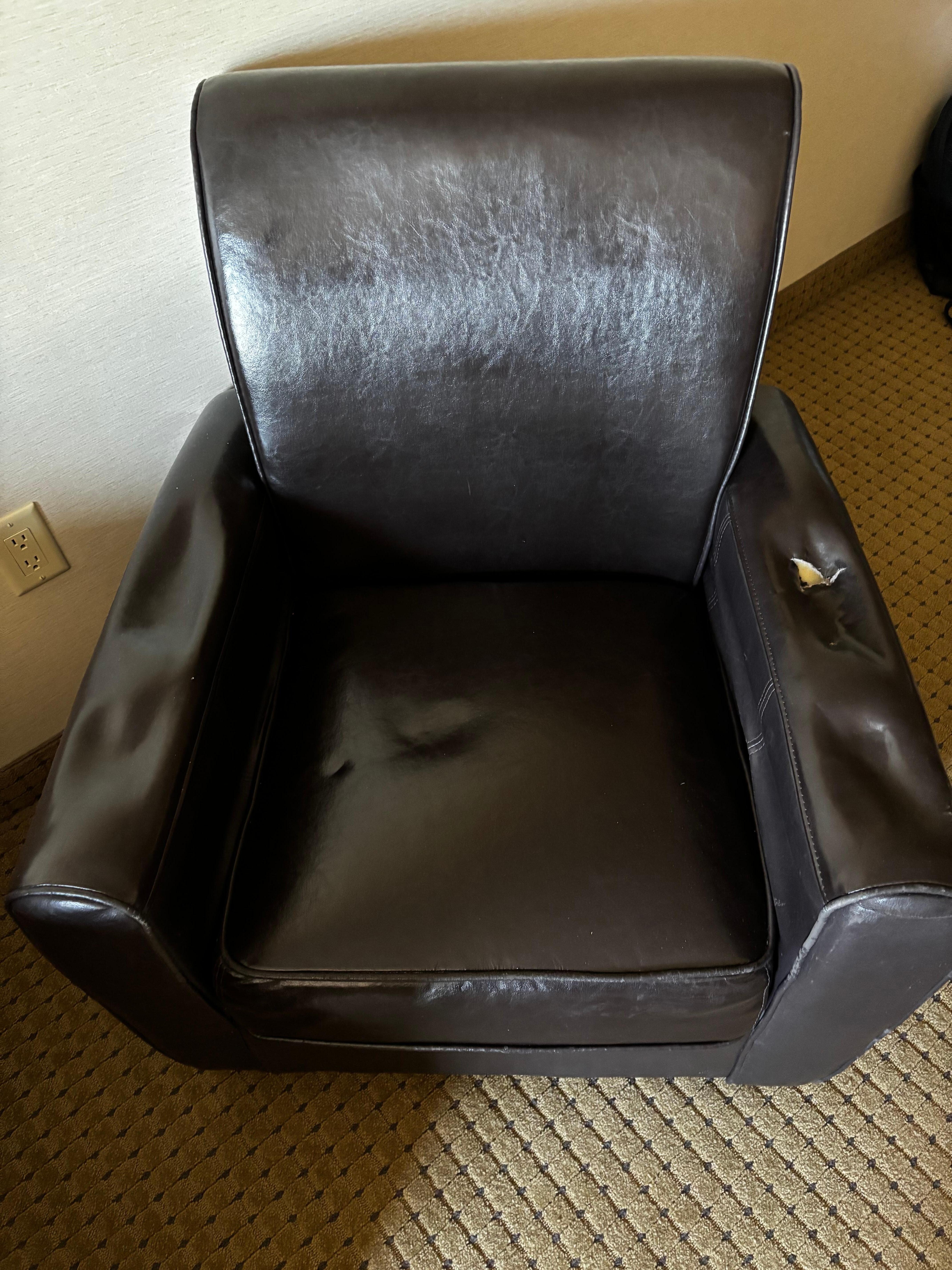 Chair with holes in armrests. Terrible condition.