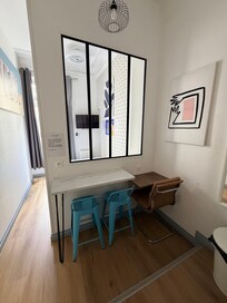 Work area between kitchen and sleep area. Good for a tall person. Electric and USB outlets are here and also by the bed.