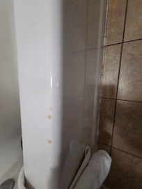 Nicotine marks on the bathtub where somebody set their cigarette