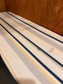 Closet/ ironing board room , filthy board , spider webs and dead bugs on the board,