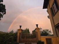 View of a rainbow over the gates to the smaller villa