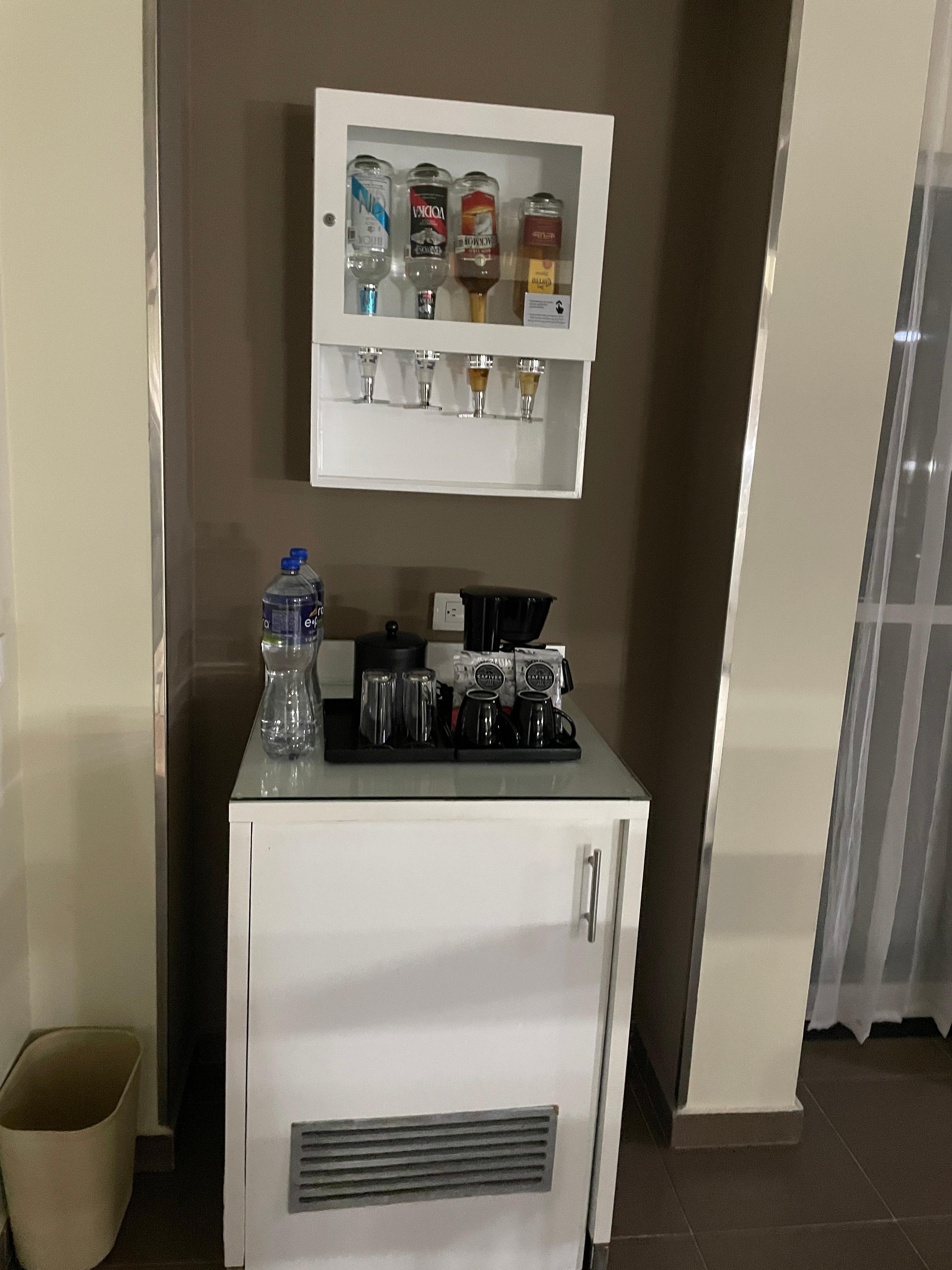 the fridge and bar in room FREE DRINKS + water daily