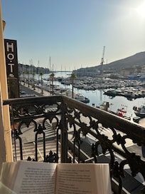 Enjoying my book on the balcony in the morning