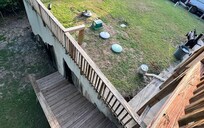 Overview of septic overflow next to the grill and going down the stairs