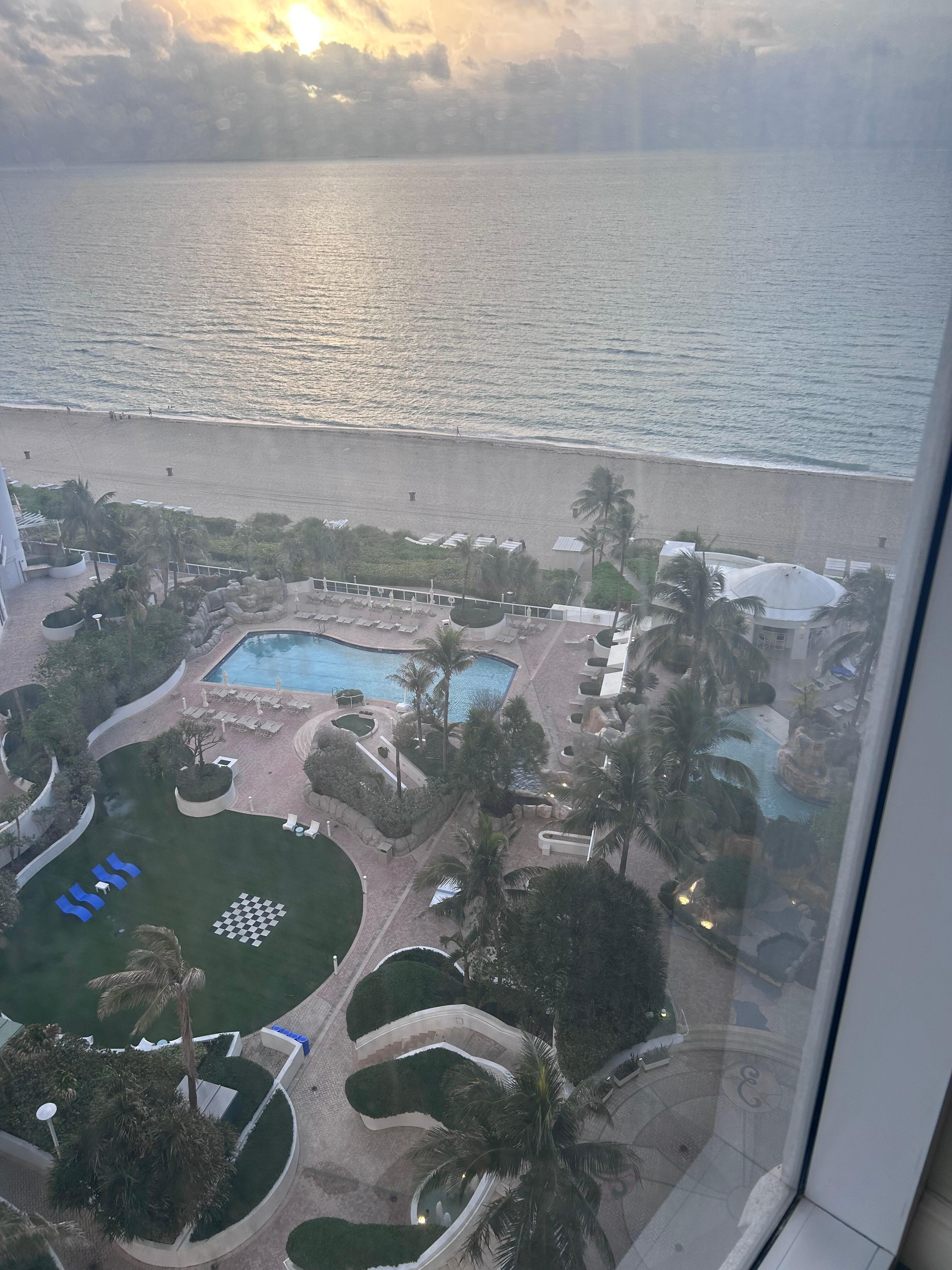 View of pool, play area and beach from room