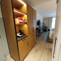 Closet with coffee maker and small refrigerator