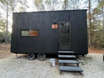 Cabin we stayed in has 2 queen beds-ample room, a tiny kitchen with supplies, fridge and 2 burner stove. Lil dining rm table/chairs-bathroom in cabin.