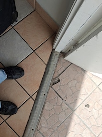 Cracked tile everywhere even by the door which was hard to open.