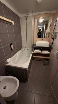 Bathroom with a bidet— toilet has separate room.