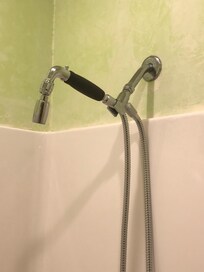 Shower head in the bathroom connecting 2 bedrooms.
