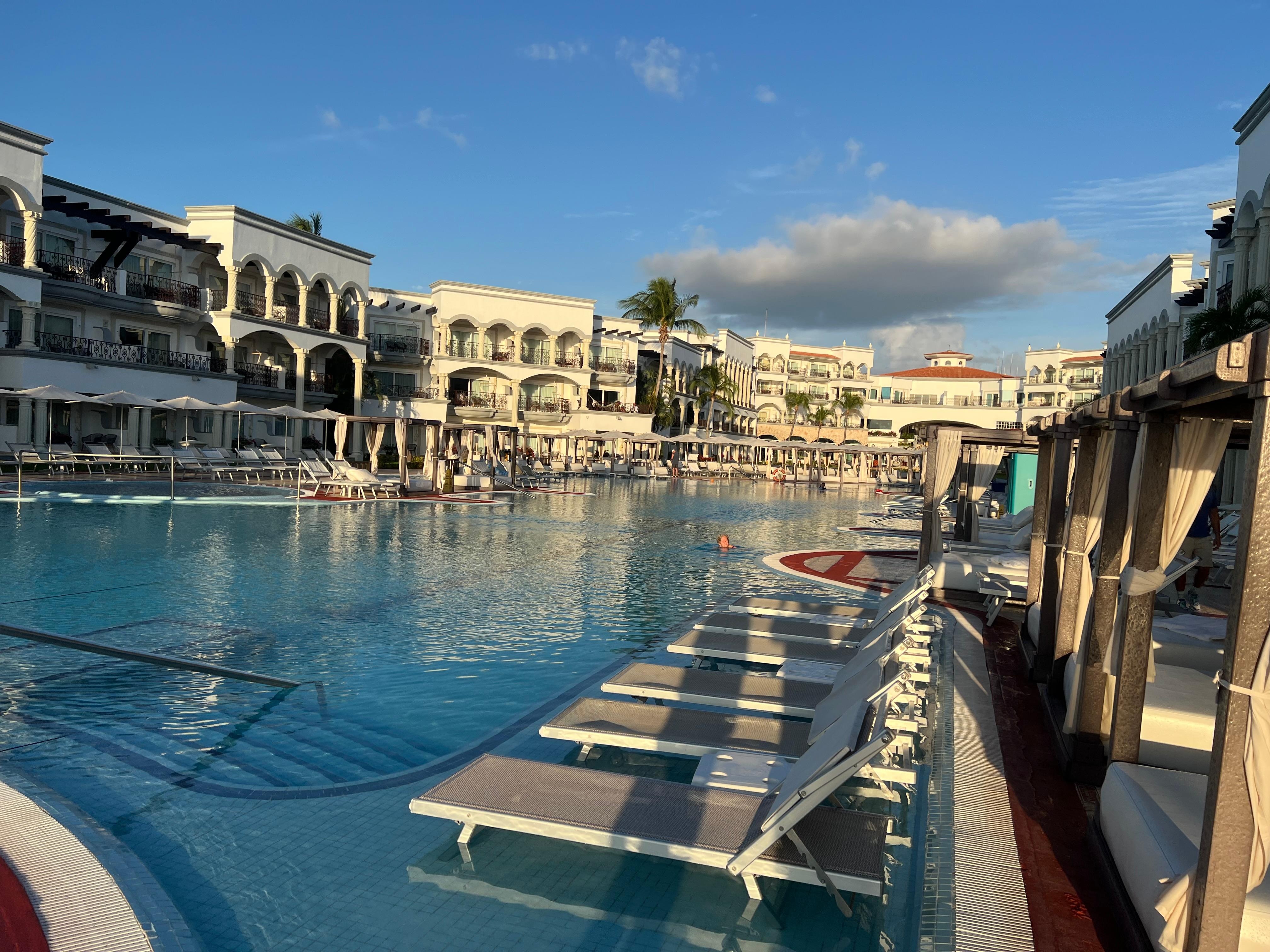 All those pool loungers are cabana reservation only.  They will move you out of them unless you paid for cabana