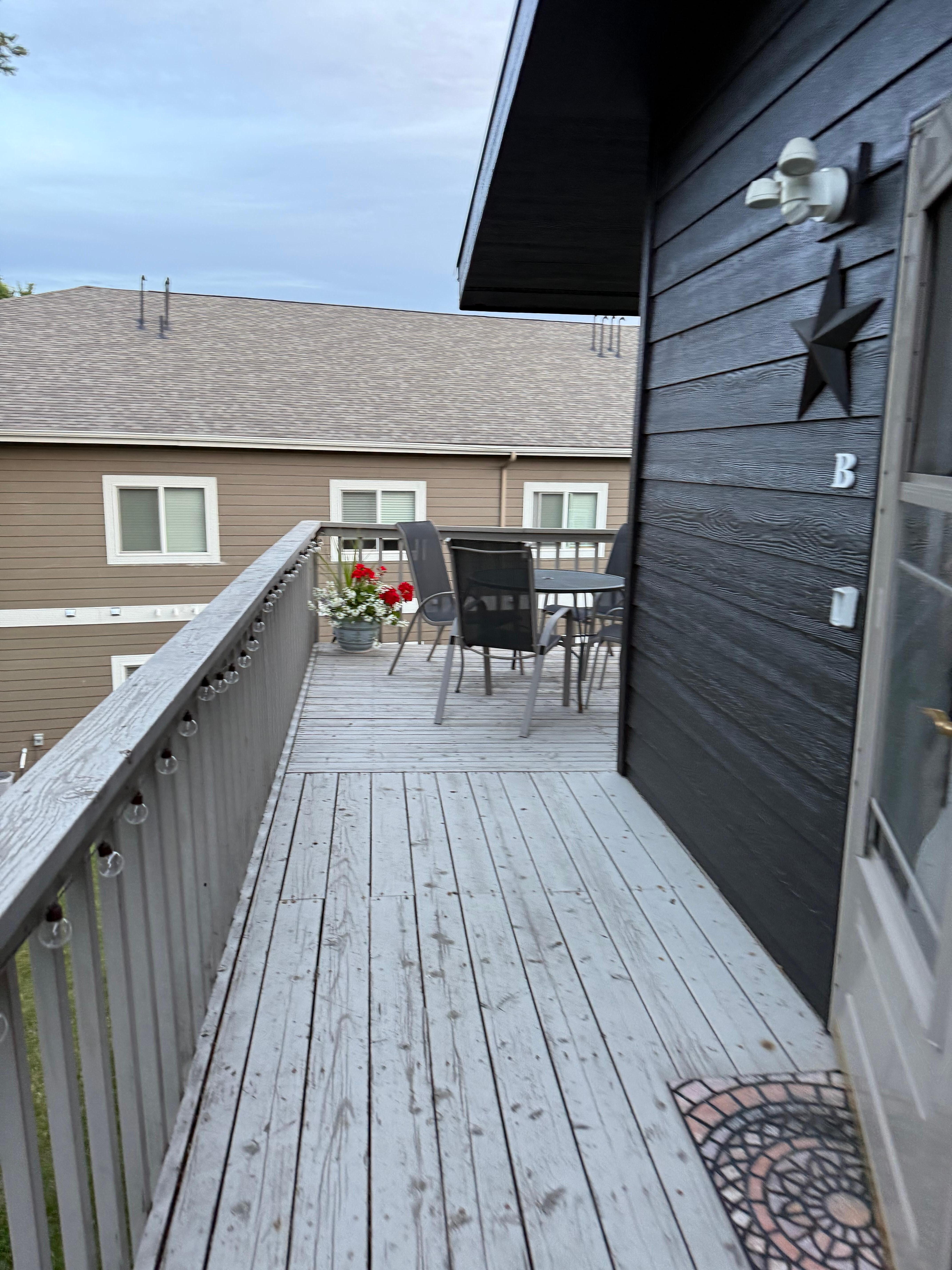 Deck sitting area with bungalow entry door