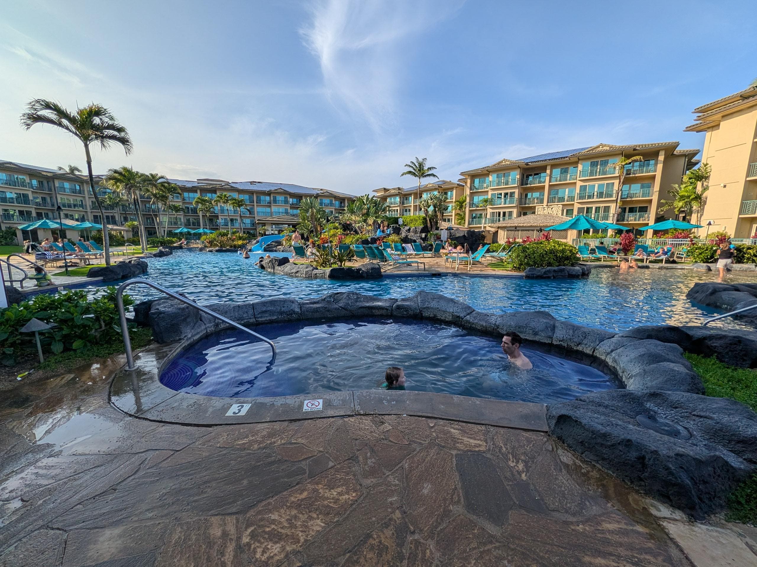 Expansive pool to lounge by with waterslides and multiple spas