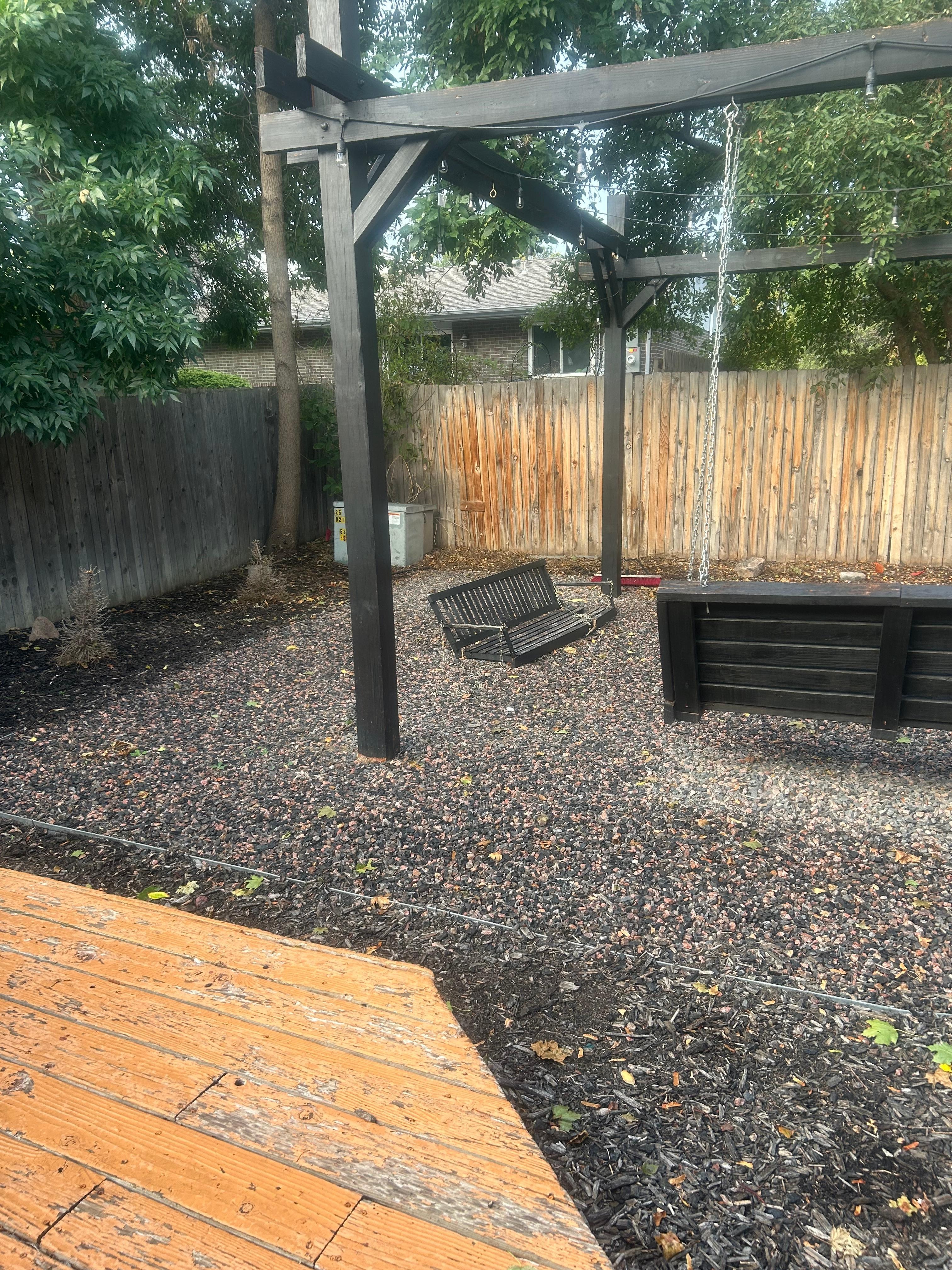 fire pit area with broken swing on the ground and no screen for the projector