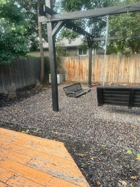 fire pit area with broken swing on the ground and no screen for the projector