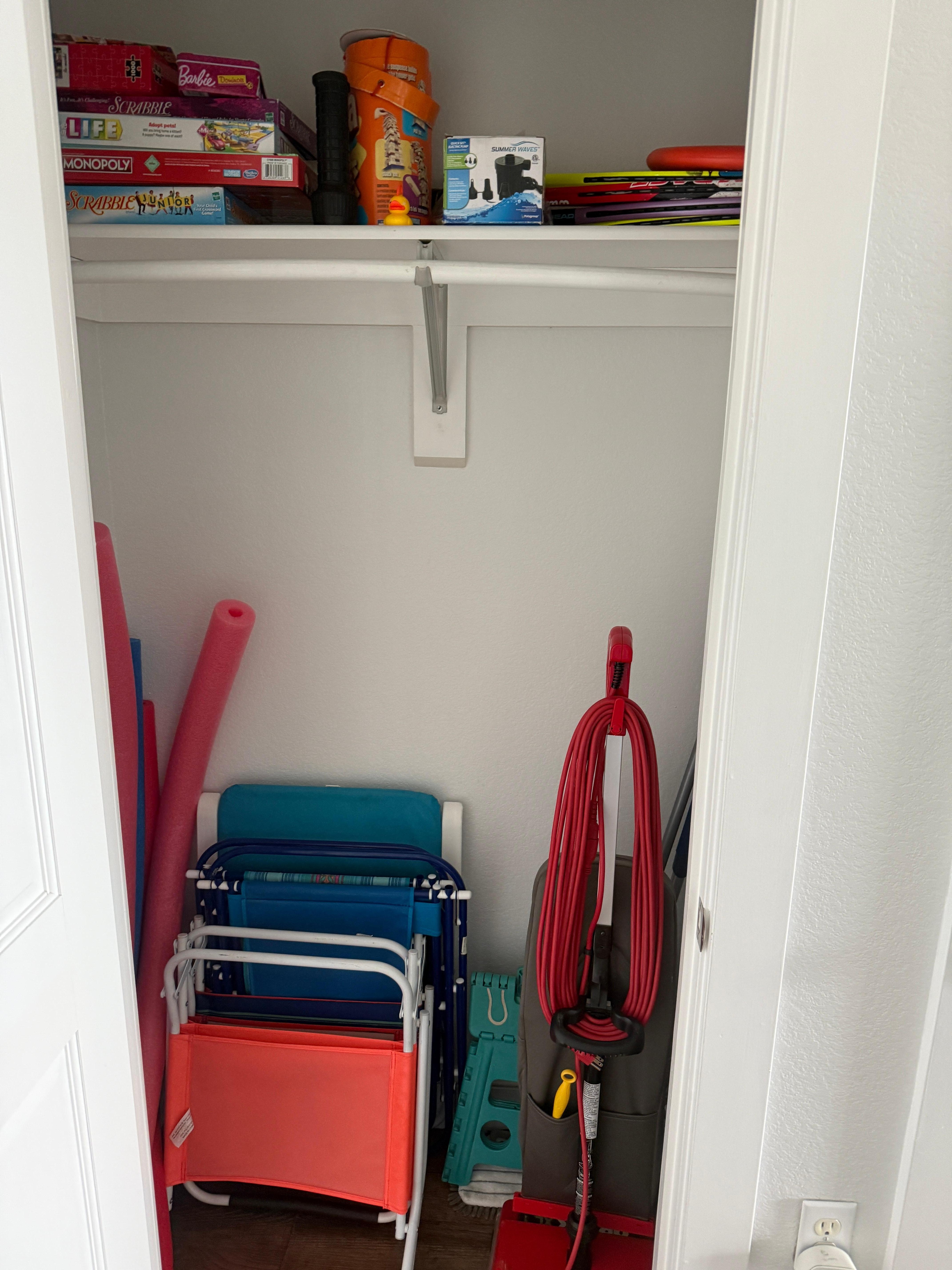 Stocked coat closet with chairs and pool noodles