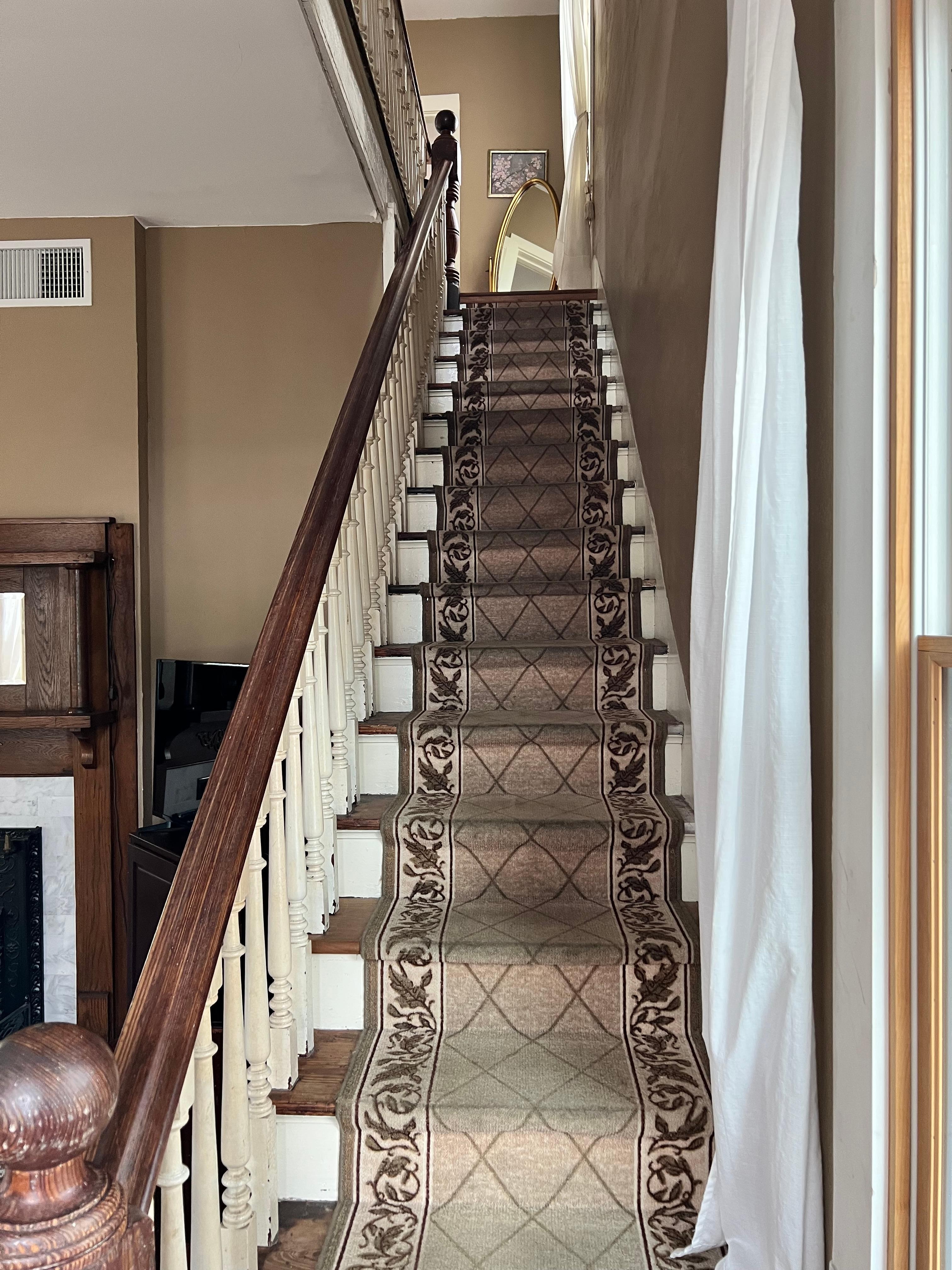 Standing at the door looking up steps. Upstairs has 2 rooms with a full bath. The one room has sliding doors to split room into 2. One of the rooms has king bed while the other has a trundle bed. The front bedroom has a queen bed.