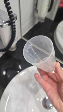 dirty plastic cup in bathroom