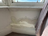 Peeling paint on walls in room
