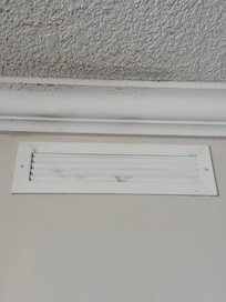 Dirty air vent and crown molding and ceiling