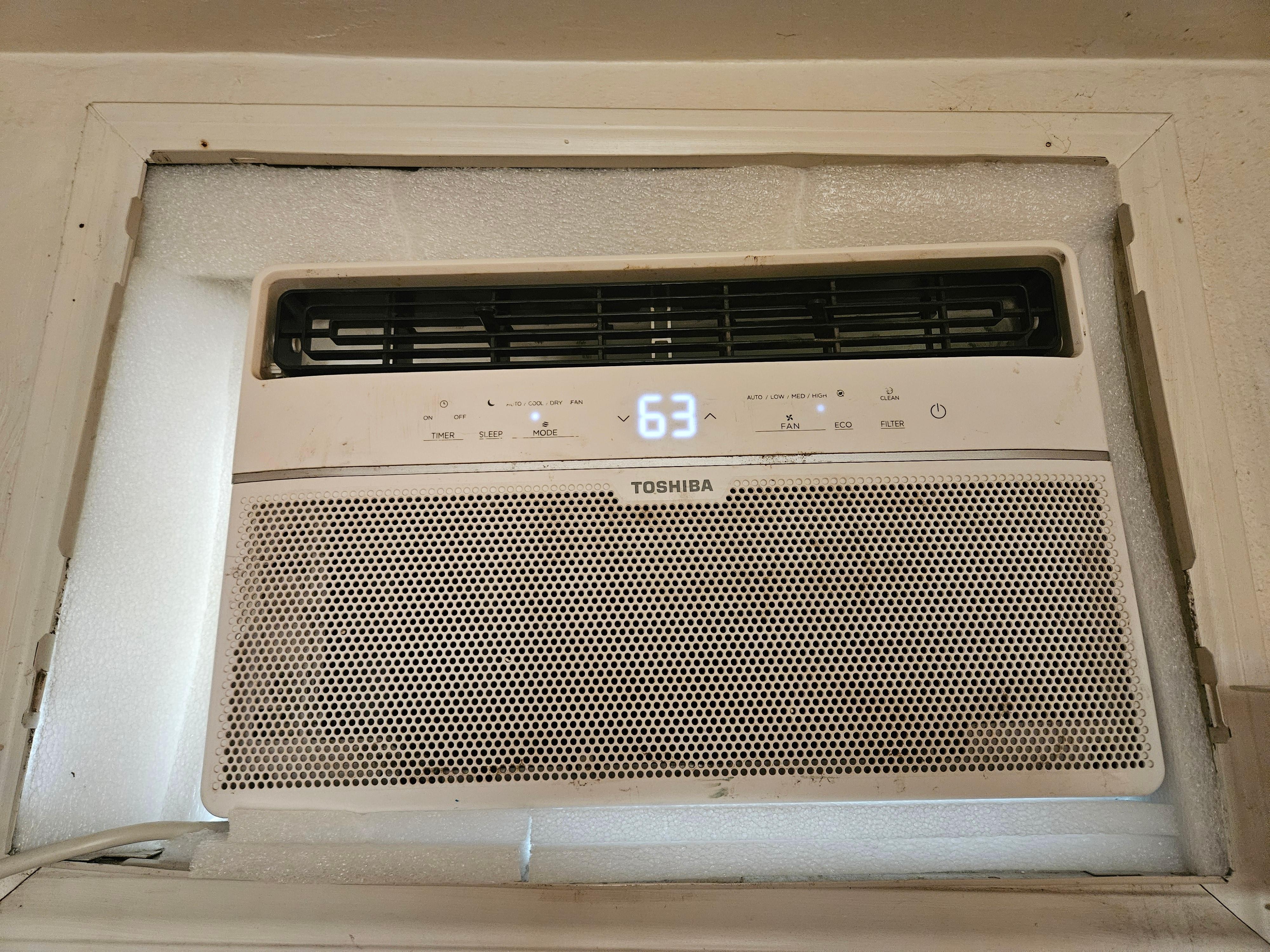 the barely working AC which had packing foam sort of packed around it, but a clear opening to the outside for bugs and warm air to go through