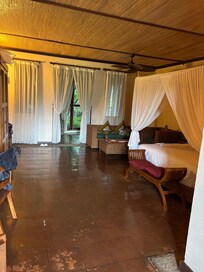 View from rice field side of view (the back) towards inside of room. Bed on right.