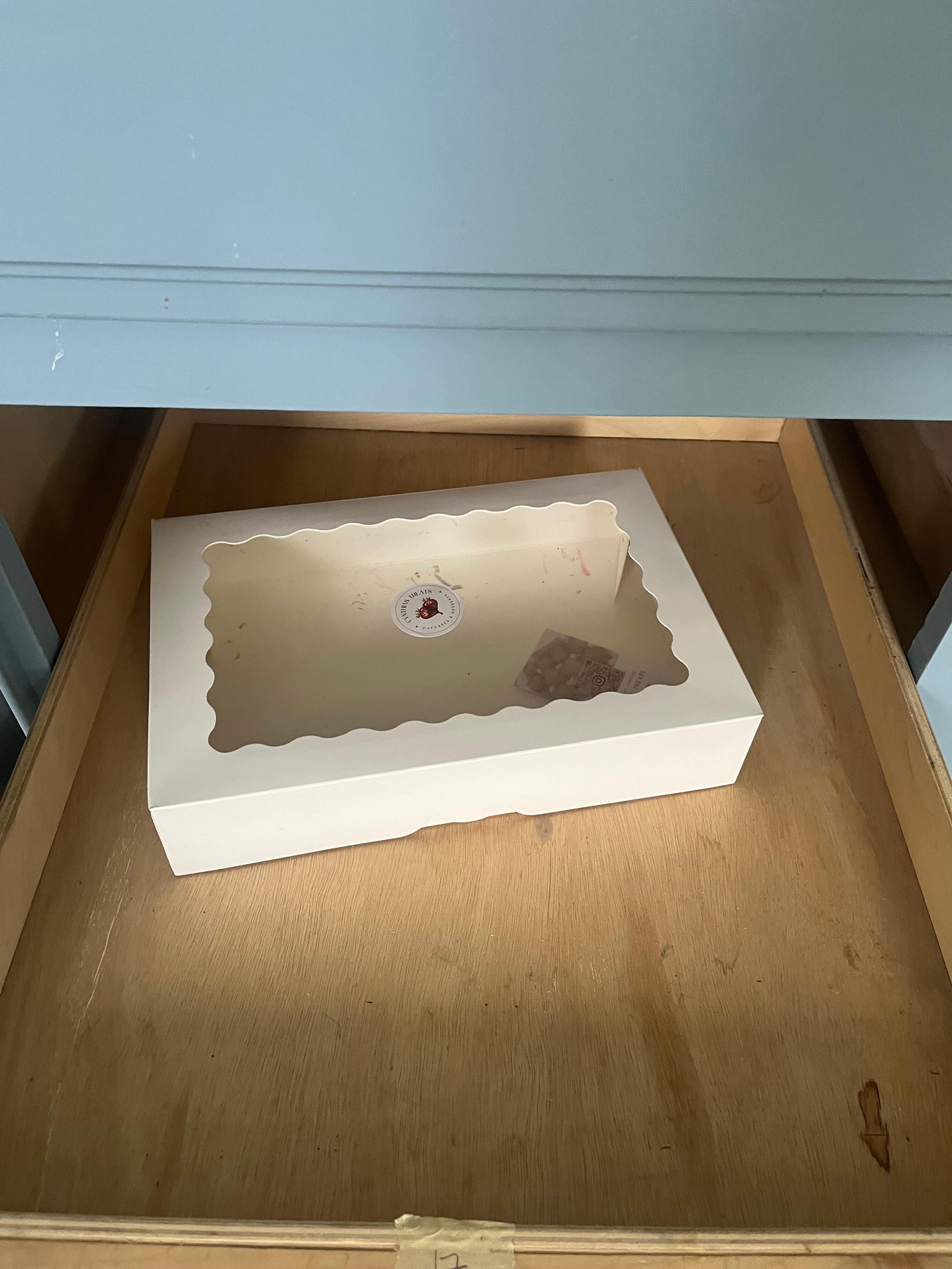 Empty pastry box in cabinet - garbage
