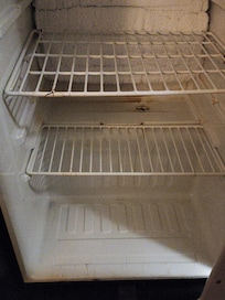 Fridge looks like it hasn't been cleaned at all in a week or so