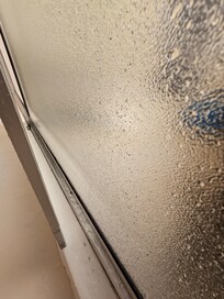 Shower doors is completely off hinges and a screw fell out.